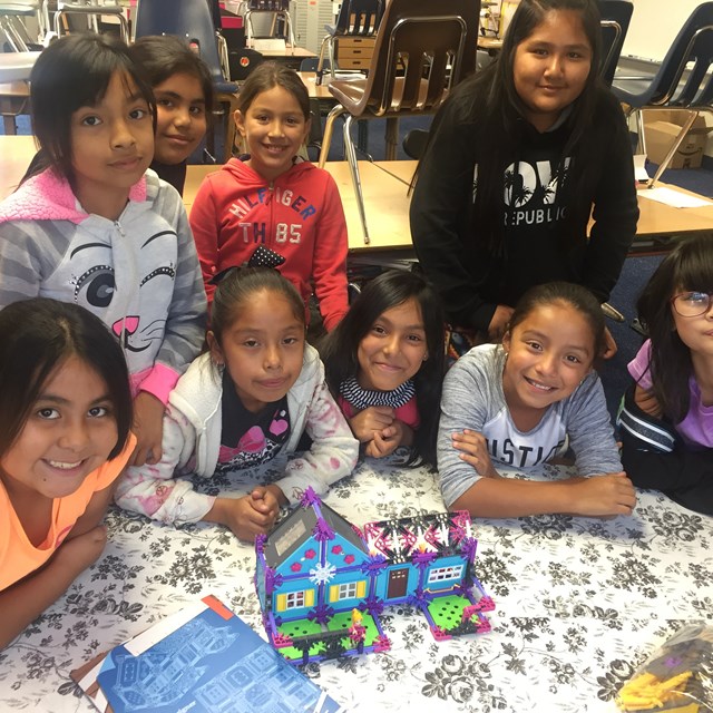 Students smile after completing their model house!