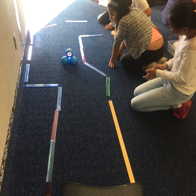 Our students master the precision that it takes to navigate the robots through a trail. 